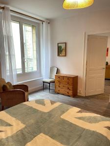 a living room with a bed and a chair and window at Appartement - Centre historique in Fougères