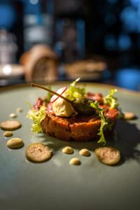 a piece of bread with a salad on a plate at Hotel la Palma au Lac in Locarno