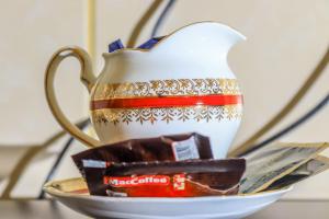 a teapot sitting on a saucer with a tea box at Farrey Homes 1 Br Kitengela in Nairobi