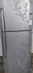 a refrigerator with birds painted on the side of it at Paradise Living in Bangalore