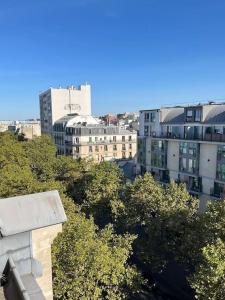 a view of a city with tall buildings and trees at Centralised Apartment in Paris in Paris +24 photos