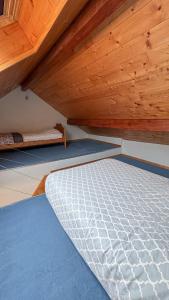 a bedroom with a mattress under a wooden ceiling at Montricher Karellis, 5 min de St Jean de Maurienne in Montricher-Albanne