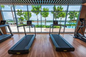 a gym with three treadmills and a large window at Setia Alam Convention Centre 3 Bedroom 2-9Pax #33 in Shah Alam