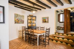 a dining room with a wooden table and chairs at 10 DEL PONT Alojamiento con vistas panorámicas in Besalú +42 photos