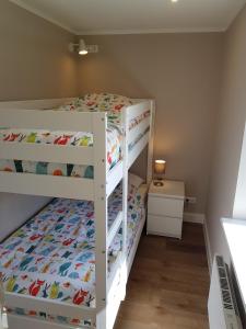 a bedroom with two bunk beds in a room at Haus Wellenrauschen in Zingst
