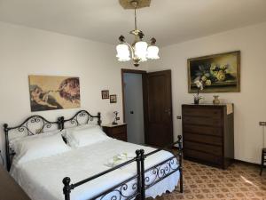 a bedroom with a bed and a dresser at La Casa Dei Nonni in Gubbio
