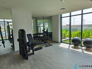 a gym with treadmills and machines in a building at Modern Contemporary Studio in Azizi Riviera in Dubai