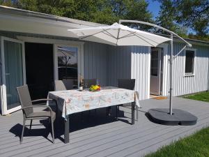 a table with an umbrella on a deck at Haus Wellenrauschen in Zingst