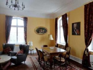 a living room with a table and chairs at Schloss Pütnitz - Kanuspezial ab 4 Ü 06 Jan bis 29 April in Ribnitz-Damgarten +70 photos