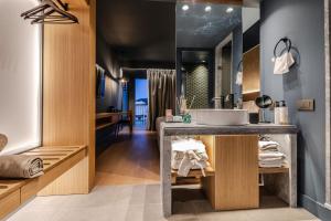 a bathroom with a sink and a mirror at Magnes Hotel in Volos +37 photos