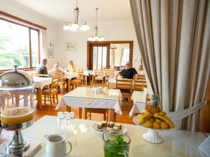 a restaurant with tables and people sitting at tables at Hotel Prinzessin Rupprecht in Swakopmund