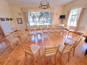 a room with a large room with chairs and a table at Hotel Prinzessin Rupprecht in Swakopmund