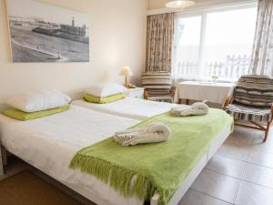 two beds in a room with towels on them at Hotel Prinzessin Rupprecht in Swakopmund