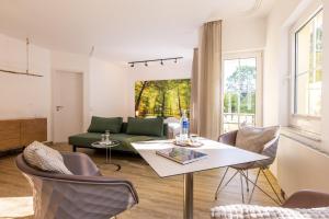 a living room with a couch and a table at Inselhotel Rügen in Göhren
