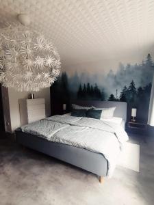 a bedroom with a bed with a painting on the wall at Augl Bischofsgrün in Bischofsgrün
