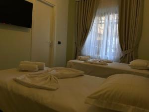 Postel nebo postele na pokoji v ubytování Amorino Tirana B&B