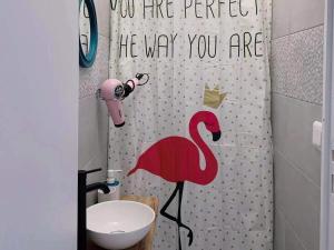 a shower curtain with a flamingo in a bathroom at Rainbow Villa, One bed in shared dormitory room, please choose male or female room correctly, not mixed, check in from 16h00 to 23h50 in Villejuif