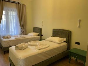 Postel nebo postele na pokoji v ubytování Amorino Tirana B&B