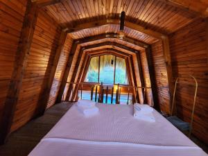 a large bed in a wooden room with a window at Doa Bungalov & Tiny House in Sapanca +60 photos