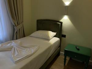Postel nebo postele na pokoji v ubytování Amorino Tirana B&B