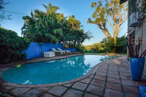 a swimming pool in a yard with trees at Ingwenya Lodge in St Lucia