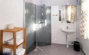 a bathroom with a shower and a sink at Hotell Krey in Karlskoga +8 photos