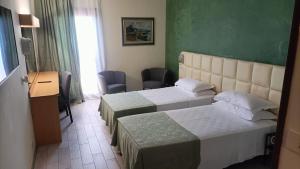 Postel nebo postele na pokoji v ubytování Hotel Delta Florence