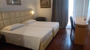 Postel nebo postele na pokoji v ubytování Hotel Delta Florence