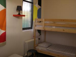 a bedroom with a bunk bed and a window at Hostel Praha Ládví in Prague