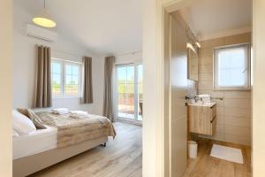 a bedroom with a bed and a bathroom at Traumhafte Finca mit Privatpool und Panoramablick in Vižinada +31 photos