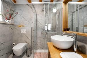 a bathroom with a sink and a glass shower at Exquisites Apartment im Herzen von Porec mit Meerblick, nur 150 Meter zum Strand in Poreč +23 photos