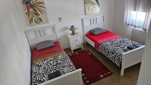 two beds in a small room withskirts at Playa del Sol-Casa Playa in Denia +27 photos