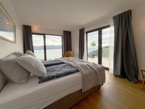 a bedroom with a bed with a large window at Villa Ena in a peaceful location with a sea view in Zagorje