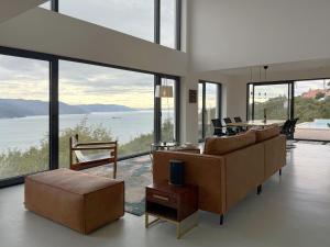 a living room with a couch and a table at Villa Ena in a peaceful location with a sea view in Zagorje