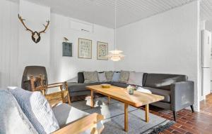 a living room with a couch and a table at 3 Bedroom Stunning Home In Skjern in Skjern