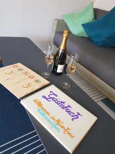 a table with a bottle of champagne and two wine glasses at Haus Wellenrauschen in Zingst