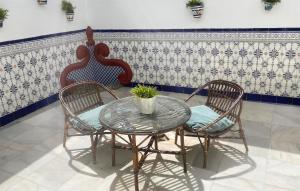 two chairs and a glass table with a table and two chairs at Gorgeous Home In Malaga in Málaga