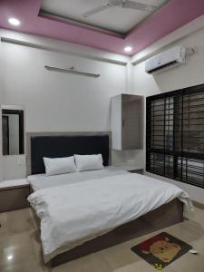 a bedroom with a large white bed in a room at Satyabhama Homestay-Opel-2 BHK Apartment in Indore