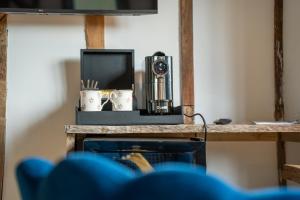a table with a camera on top of it at The Barn at Chart Hills in Biddenden