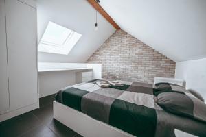 a small bedroom with a bed in a attic at Wake Up Esch City in Esch-sur-Alzette