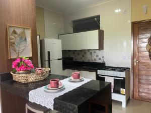 a kitchen with a counter with two mugs on it at Flat Ilha Bela 22525 in Alter do Chao