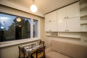 a living room with a table and a window at Song Festival apartment 5-10 minutes from airport, bus station, festival area in Tallinn +48 photos