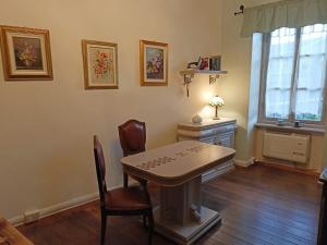 a dining room with a table and chairs and a window at Il Grappolo in Giaveno
