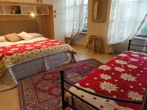 a bedroom with a bed with a red blanket at Il Grappolo in Giaveno