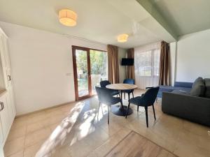 a living room with a table and chairs and a couch at Kiara Apartments in Saints Constantine and Helena
