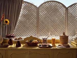 a table with plates of food and candles on it at Memories Apartments - Explore & Recharge in Laganas +25 photos