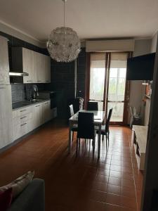 a kitchen and dining room with a table and chairs at La Casa di Pablo B&B in Ferrara