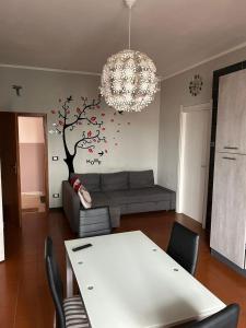 a living room with a table and a tree on the wall at La Casa di Pablo B&B in Ferrara +1 photo