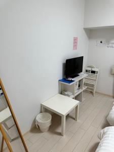 Televiisor ja/või meelelahutuskeskus majutusasutuses Residence天王寺東