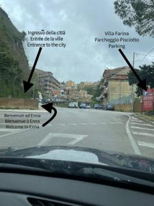 a view from a car window of an empty street at Cozy House in Enna